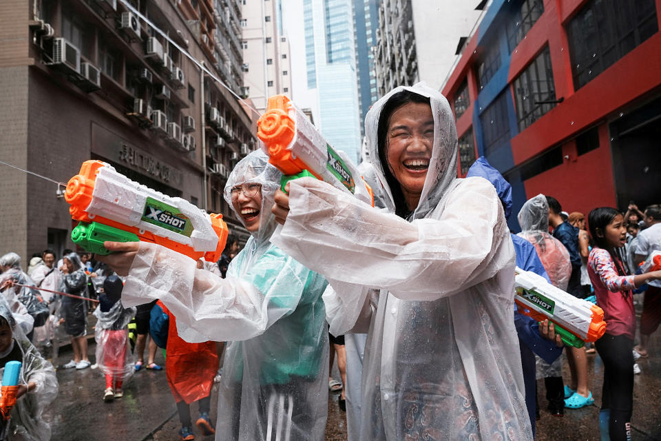 Revelers react in a water fight during Songkran Festival celebrations, in Hong Kong, China, on April 9, 2023. 