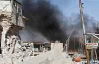 Smoke billows from the ruins of Grand al-Nuri Mosque after it was retaken by the Iraqi forces from the Islamic State militants at the Old City in Mosul, Iraq June 29, 2017. REUTERS/Erik De Castro