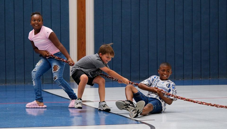 Children play tug-of-war during a Movement Minute session as part of the Project Transformation summer literacy day camp at New Hope United Methodist Church.