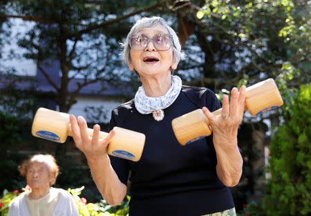 Elderly and middle-aged people exercise with wooden dumbbells during a health promotion event to mark Japan's "Respect for the Aged Day" at a temple in Tokyo's Sugamo district, an area popular among the Japanese elderly, Japan, September 18, 2017. REUTERS/Toru Hanai