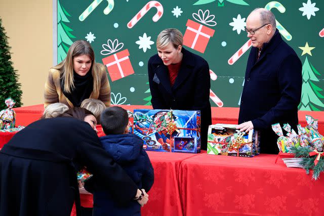 <p>VALERY HACHE/POOL/AFP via Getty</p> Camille Gottlieb, Prince Albert and Princess Charlene of Monaco at Prince's Palace of Monaco on Dec. 20.