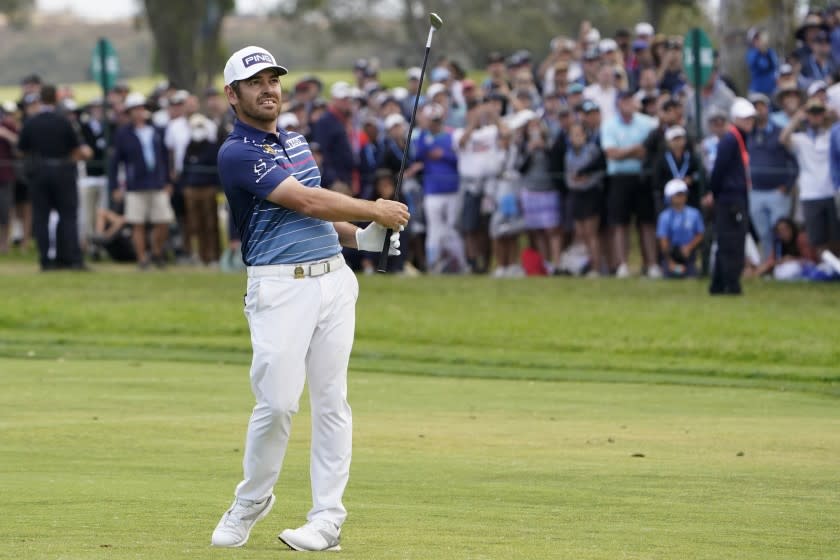 Louis Oosthuizen, of South Africa, hits from the 18th fairway during the final round of the U.S. Open Golf Championship.