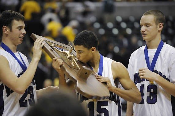 The Panthers’ Dee Davis kisses the championship trophy on the podium after Bloomington High School South won the the IHSAA Class 4A state boys’ basketball championship March 28 at Conseco Fieldhouse in Indianapolis. H-T staffers and readers both voted the Panthers’ undefeated, state championship season the top local story of 2009. Monty Howell | Herald-Times