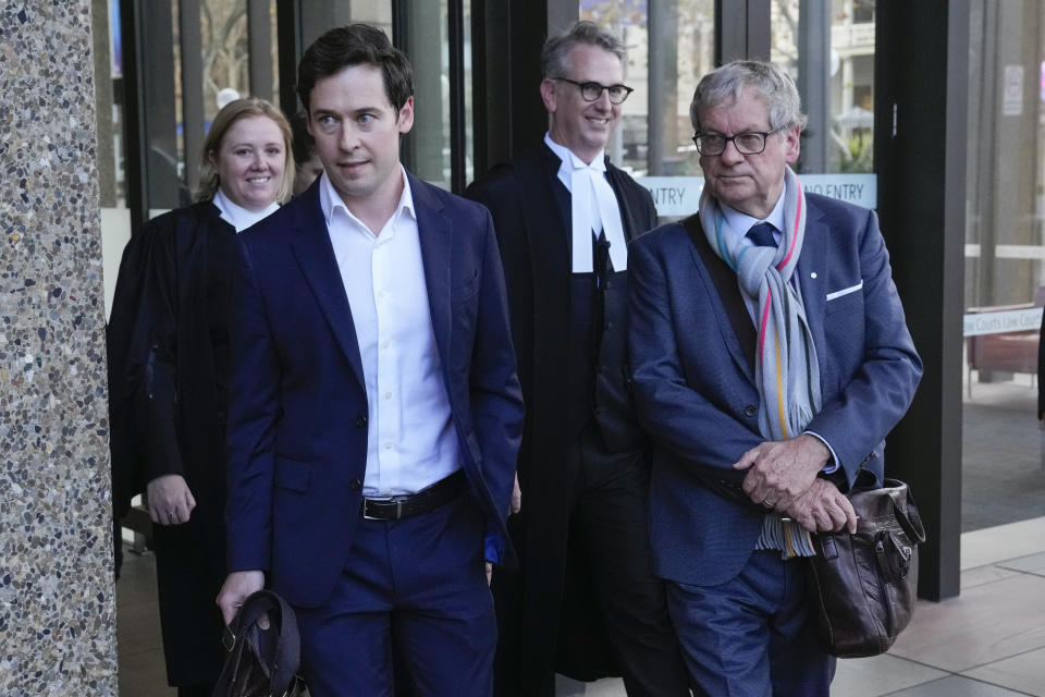 Australian journalists Nick McKenzie, second left, and Chris Masters, right, walk with their legal team from the Federal Court in Sydney, Australia, Thursday, June 1, 2023. Australia’s most decorated living war veteran unlawfully killed prisoners and committed other war crimes in Afghanistan, a judge ruled Thursday in dismissing the claims by Victoria Cross recipient Ben Roberts-Smith that he was defamed by media. (AP Photo/Mark Baker)