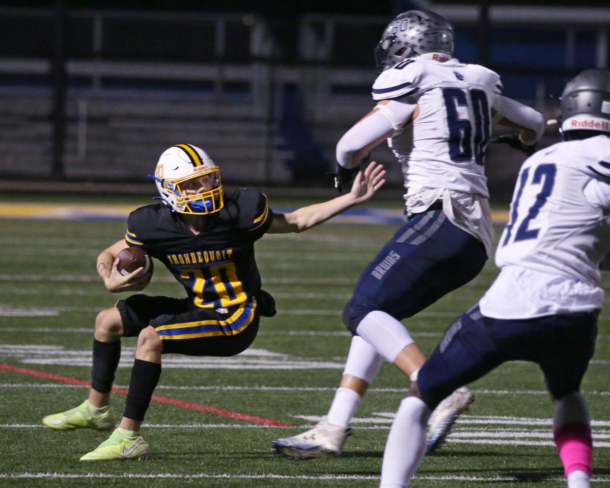 Irondequoit quarterback Steven Clinkscales puts the breaks on as he avoids the sack attempt by Brighton's Val Kondratenko.