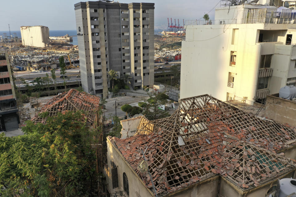 Damaged heritage houses overlooking the site of the Aug. 4 explosion that hit the seaport of Beirut, Lebanon, Thursday Aug. 27, 2020. In the streets of Beirut historic neighborhoods, workers are erecting scaffolding to support buildings that have stood for more than a century - now at risk of collapse after the massive Aug. 4 explosion that tore through the capital. The explosion damaged thousands of buildings, including dozens of Ottoman and French mandate-era structures that had been among the few survivors of a years-old construction frenzy replacing traditional houses with modern buildings. (AP Photo/Hussein Malla)