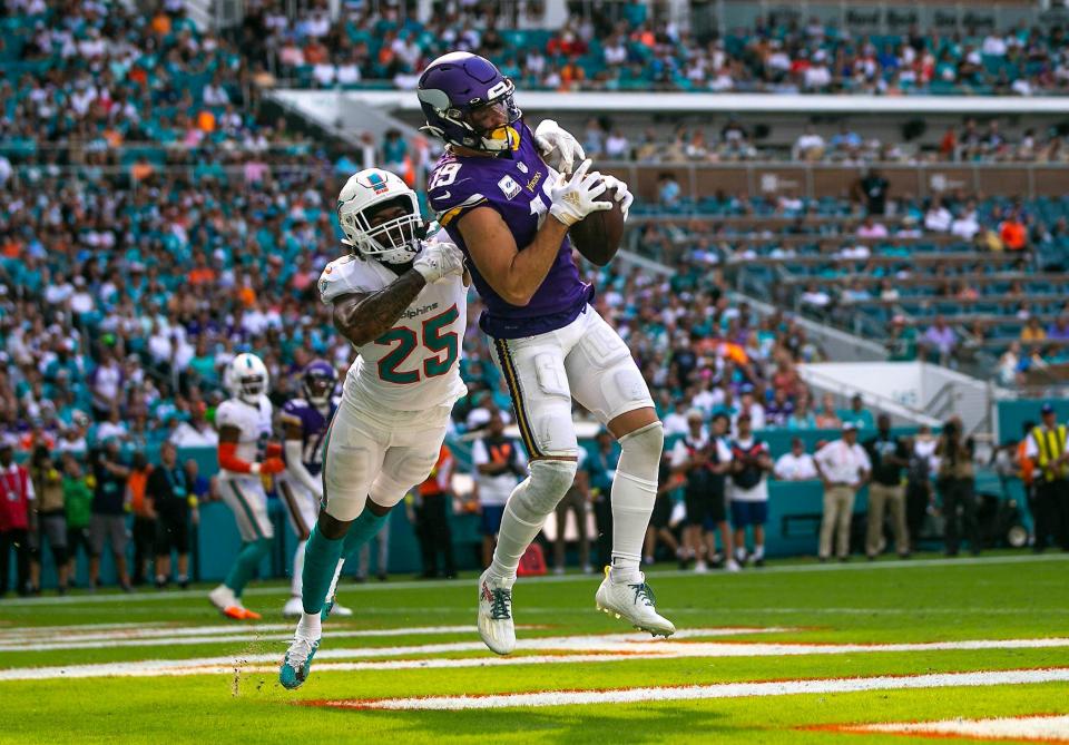 Vikings receiver Adam Thielen makes a touchdown catch in the fourth quarter while Dolphins cornerback Xavien Howard attempts to defend during Sunday's game at Hard Rock Stadium.