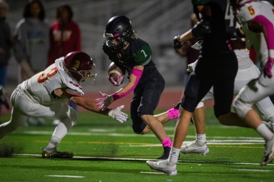 Fossil Ridge football quarterback/running back Colton Pawlak carries the ball for a touchdown against Rocky Mountain during their game at PSD Stadium in Timnath on Friday, Oct. 14, 2022.