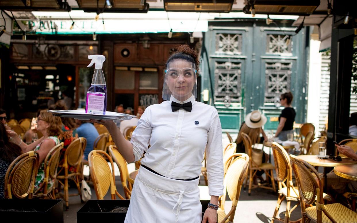 Waitresses wear PPE to serve customers