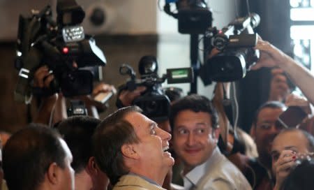 Presidential candidate Jair Bolsonaro reacts as he talks to media after a visit to Federal Police headquarters in Rio de Janeiro, Brazil October 17, 2018. REUTERS/Ricardo Moraes