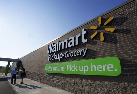 People talk outside a Wal-Mart Pickup-Grocery test store in Bentonville, Arkansas, in this file photo taken June 4, 2015. REUTERS/Rick Wilking/Files