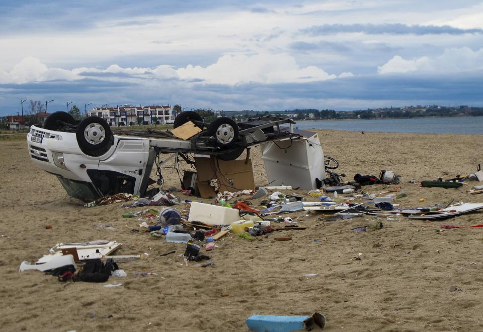 An overturned vehicle is seen on a beach at Sozopoli village in Halkidiki region, northern Greece, Thursday, July 11, 2019. A powerful storm hit northern Greece late Wednesday. (Giannis Moisiadis/InTime News via AP)