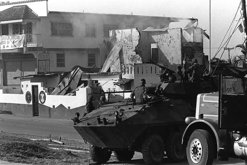 Marines of Company D, 2nd Light Armored Infantry Battalion, stand guard with their LAV-25 light armored vehicles outside a destroyed Panamanian Defense Force building during the first day of Operation Just Cause on December 20, 1989. File Photo courtesy the U.S. Marine Corps