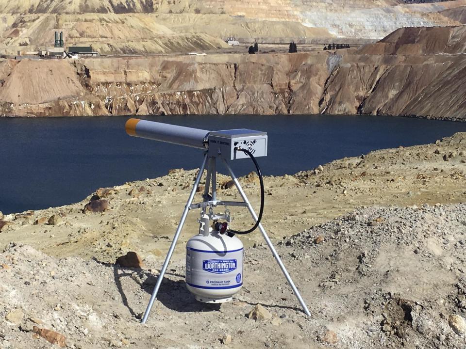 In this photo provided by Montana Resources, a propane-powered noise cannon sits at the edge of the Berkeley Pit in Butte, Montana, on March 3, 2017. The cannon is one of several new measures being taken to keep birds away from the 50 billion gallon toxic pit after 3,000 to 4,000 snow geese died there last fall. (Pete Steilman/Montana Resources, via AP)