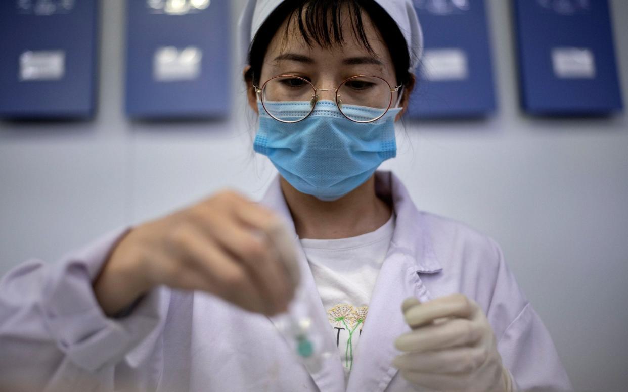 A worker packages a vaccine - AFP