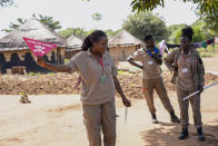 Staff from the Mines Advisory Group (MAG) teach children about the risks of unexploded mines, in Moli village, Eastern Equatoria state, in South Sudan Friday, May 12, 2023. As South Sudanese trickle back into the country after a peace deal was signed in 2018 to end a five-year civil war, many are returning to areas riddled with mines left from decades of conflict. (AP Photo/Sam Mednick)