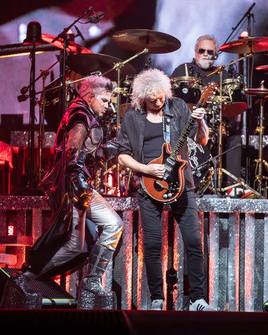 <p>Miikka Skaffari/Getty</p> Adam Lambert performs with Brian May and Roger Taylor of Queen