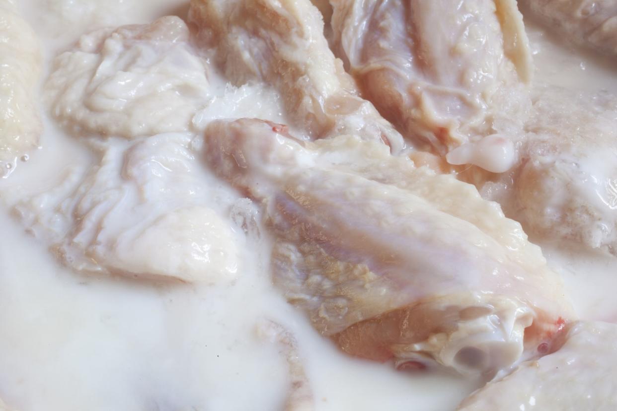 raw chicken marinating in buttermilk