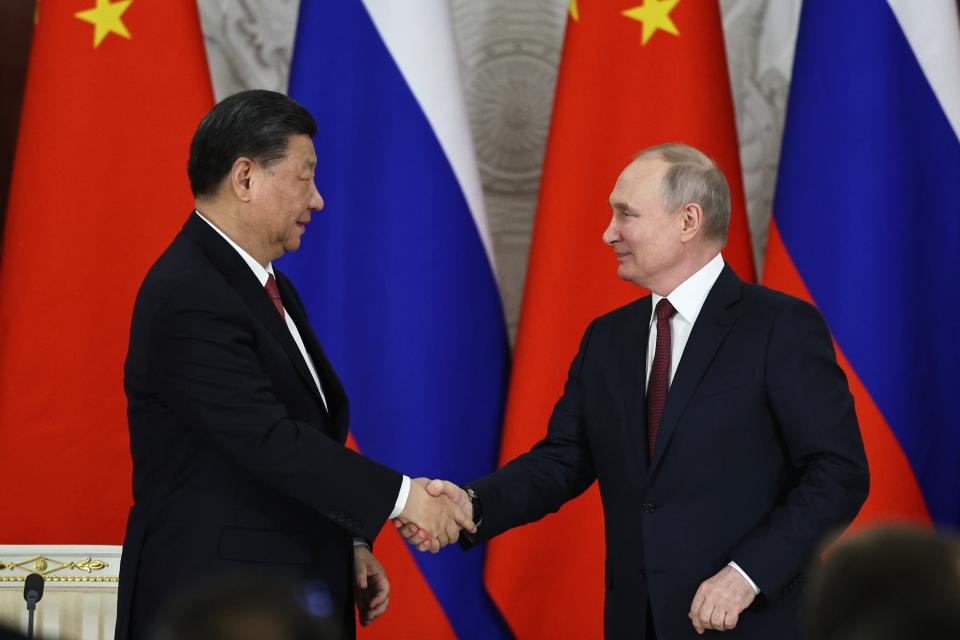 Russian President Vladimir Putin, right, and Chinese President Xi Jinping shake hands after speaking to the media during a signing ceremony following their talks at The Grand Kremlin Palace, in Moscow, Russia, Tuesday, March 21, 2023. (Mikhail Tereshchenko, Sputnik, Kremlin Pool Photo via AP)