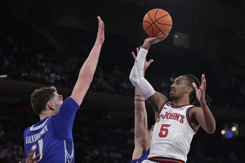 St. John's guard Daniss Jenkins (5) shoots over Creighton center Ryan Kalkbrenner during the second half of an NCAA college basketball game, Sunday, Feb. 25, 2024, in New York. (AP Photo/Adam Hunger)