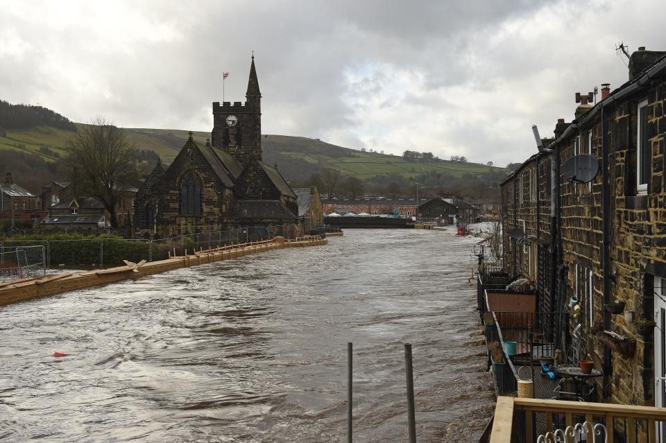 Newly constructed flood defenses are seen beside the River Calder in Mytholmroyd, northern England, on February 9, 2020, insufficient to prevent the river bursting its banks and flooding the village as Storm Ciara swept over the country. - Britain and Ireland hunkered down Sunday for a powerful storm expected to disrupt air, rail and sea links, cancel sports events, cut electrical power and damage property. With howling winds and driving rain, forecasters said Ciara would also hit France, Belgium, the Netherlands, Switzerland and Germany. (Photo by Oli SCARFF / AFP) (Photo by OLI SCARFF/AFP via Getty Images)