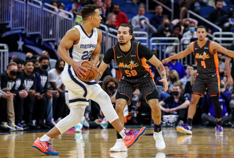 Feb 5, 2022; Orlando, Florida, USA; Memphis Grizzlies guard Desmond Bane (22) looks to pass against Orlando Magic guard Cole Anthony (50) during the first quarter at Amway Center. Mandatory Credit: Mike Watters-USA TODAY Sports