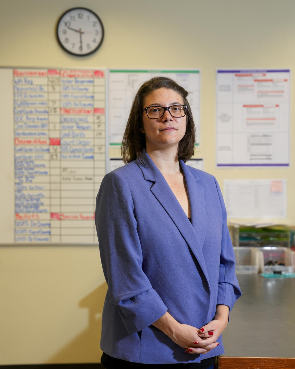 Halei Watkins, communications manager for King County Elections, poses for a portrait in the mail room at elections headquarters, Friday, Nov. 17, 2023, in Renton, Wash. The office began stocking Narcan, the nasal spray version of overdose-reversal drug naloxone, after receiving a letter laced with fentanyl in the summer and was evacuated the day after Election Day after receiving a similar envelope. (AP Photo/Lindsey Wasson)