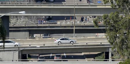 Cars travel on city streets and highway overpasses in San Diego, California, U.S. in this February 10, 2016 file photo. REUTERS/Mike Blake/File Photo