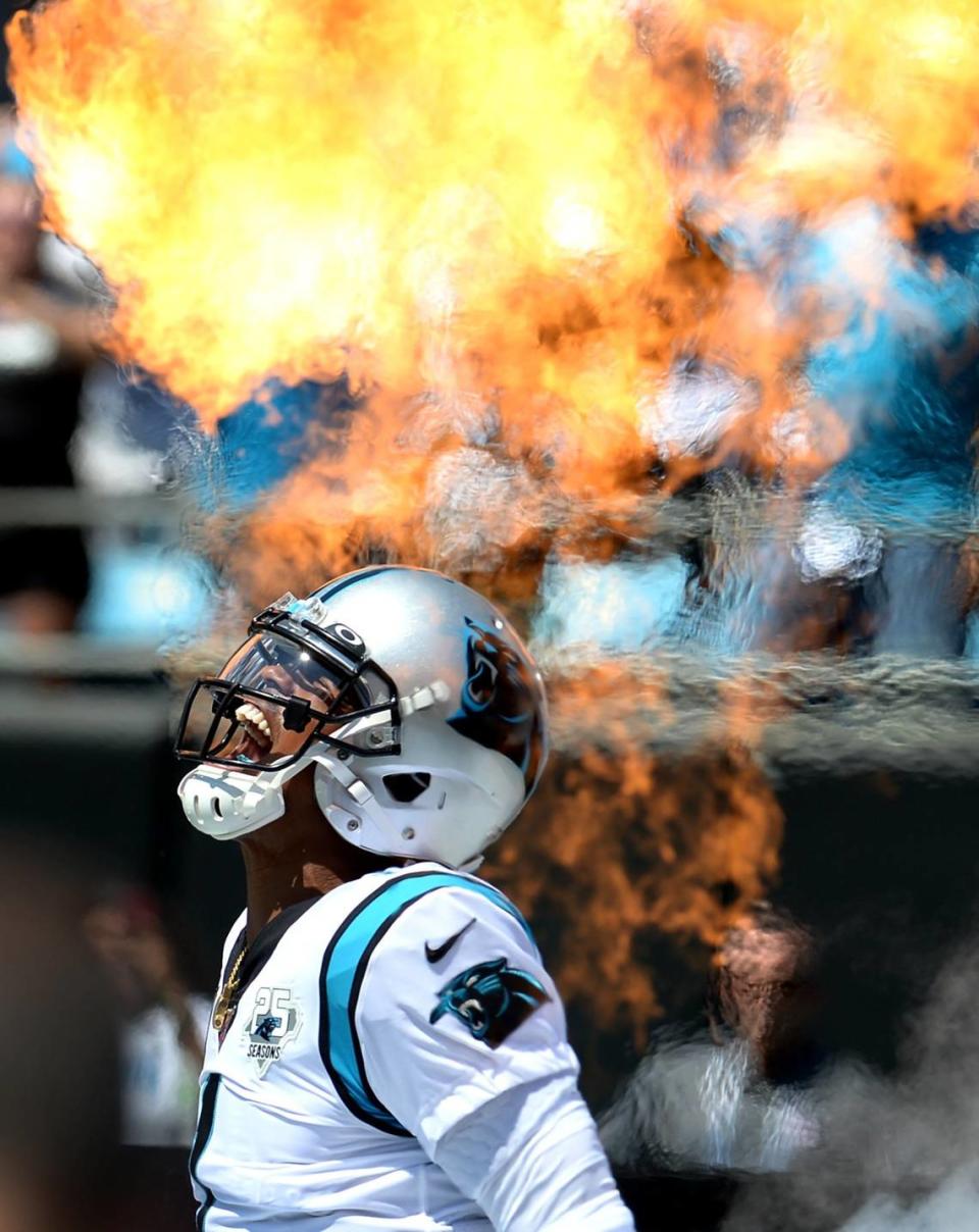 Carolina Panthers quarterback Cam Newton yells as he is introduced through shooting flames at Bank of America Stadium in 2019.