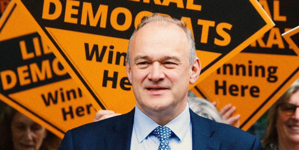 lib dem leader ed davey in front of orange lib dem signs