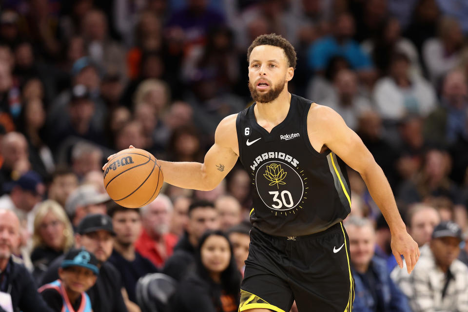 PHOENIX, ARIZONA - NOVEMBER 16:  Stephen Curry #30 of the Golden State Warriors handles the ball during the first half of the NBA game at Footprint Center on November 16, 2022 in Phoenix, Arizona. NOTE TO USER: User expressly acknowledges and agrees that, by downloading and or using this photograph, User is consenting to the terms and conditions of the Getty Images License Agreement.  (Photo by Christian Petersen/Getty Images)