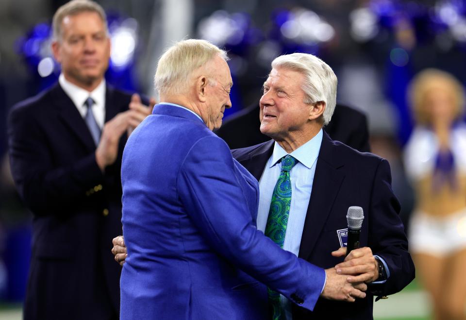 Former head coach Jimmy Johnson (R) talks with owner Jerry Jones (L) during the Dallas Cowboys Ring of Honor ceremony at halftime in the game between the Detroit Lions and the Dallas Cowboys at AT&T Stadium on December 30, 2023 in Arlington, Texas.