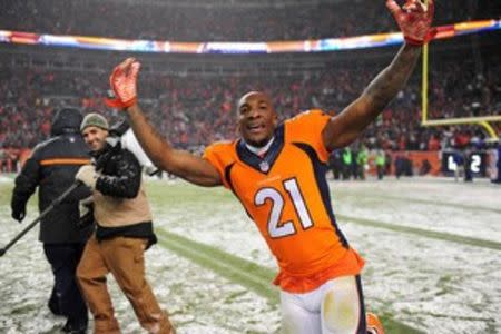 Denver Broncos cornerback Aqib Talib (21) celebrates following the overtime against the New England Patriots at Sports Authority Field at Mile High. The Broncos defeated the Patriots 30-24 in overtime. Mandatory Credit: Ron Chenoy-USA TODAY Sports