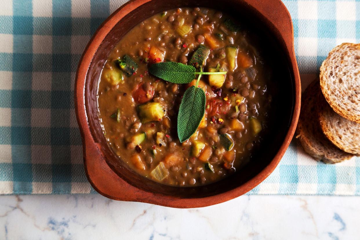 rustic lentil Soup with Crusty Bread on the table