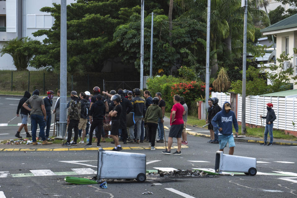 Residents gather in a street in Noumea, New Caledonia, Wednesday May 15, 2024. France has imposed a state of emergency in the French Pacific territory of New Caledonia. The measures imposed on Wednesday for at least 12 days boost security forces' powers to quell deadly unrest that has left four people dead, erupting after protests over voting reforms. (AP Photo/Nicolas Job)