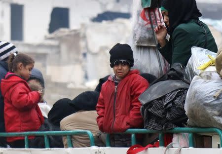 A child reacts while waiting with others to be evacuated from a rebel-held sector of eastern Aleppo, Syria December 16, 2016. REUTERS/Abdalrhman Ismail