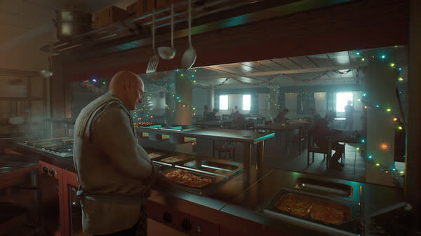  A cheff cooking in a kitchen with fairy lights in the background. 