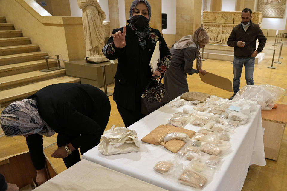 Iraqi antiquities are put on display during a ceremony held at the National Museum of Beirut before 337 artifacts were handed over by Lebanese Minister of Culture Mohammed Murtada to Iraq's ambassador to Lebanon, in Beirut, Lebanon, Sunday, Feb. 6, 2022. Until they were handed over, the artifacts had been kept at the private Nabu Museum in north Lebanon. (AP Photo/Bilal Hussein)