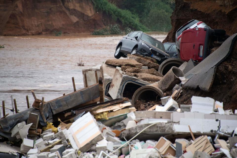 TOPSHOT - Damaged cars lie in the rubble in an area completely destroyed by the floods in the Blessem district of Erftstadt, western Germany, on July 16, 2021. - The death toll from devastating floods in Europe soared to at least 126 on July 16, most in western Germany where emergency responders were frantically searching for missing people. (Photo by SEBASTIEN BOZON / AFP) (Photo by SEBASTIEN BOZON/AFP via Getty Images)