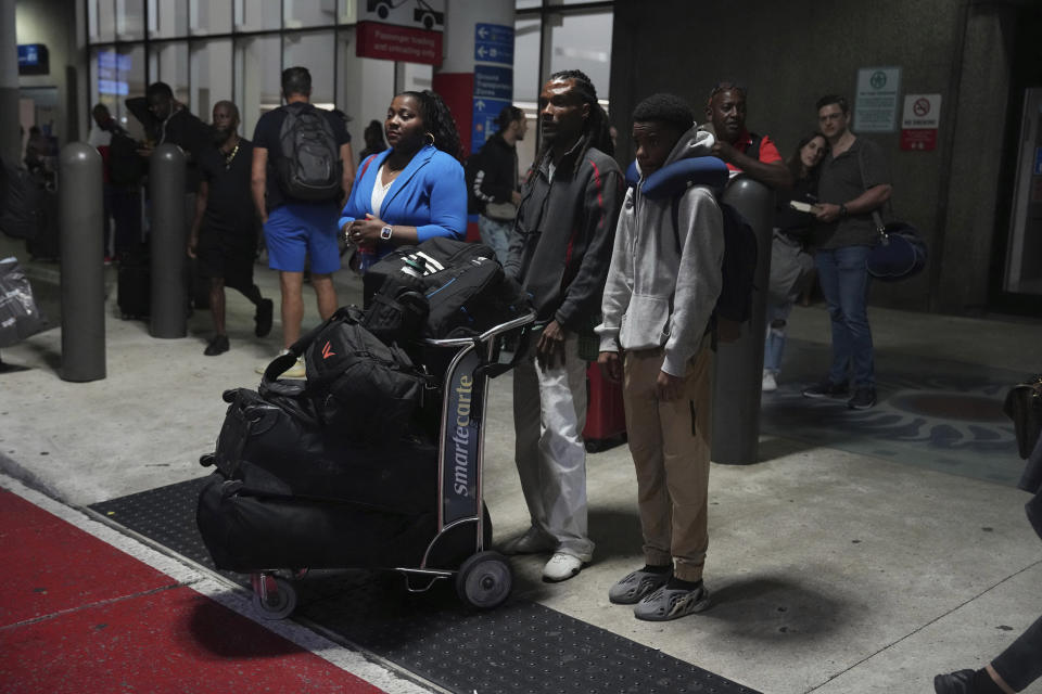 Valerie Laveus stands with her brother Reginald Malherbe Daniel and her nephew Tristan-Ryan Malherbe Daniel after her relatives arrived for the first time to the United States from Haiti at Fort Lauderdale-Hollywood International Airport, in Fort Lauderdale, Fla., Wednesday, Aug. 9, 2023. (AP Photo/Jim Rassol)