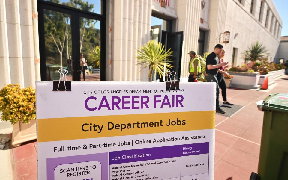 People enter and depart a jobs fair in Los Angeles