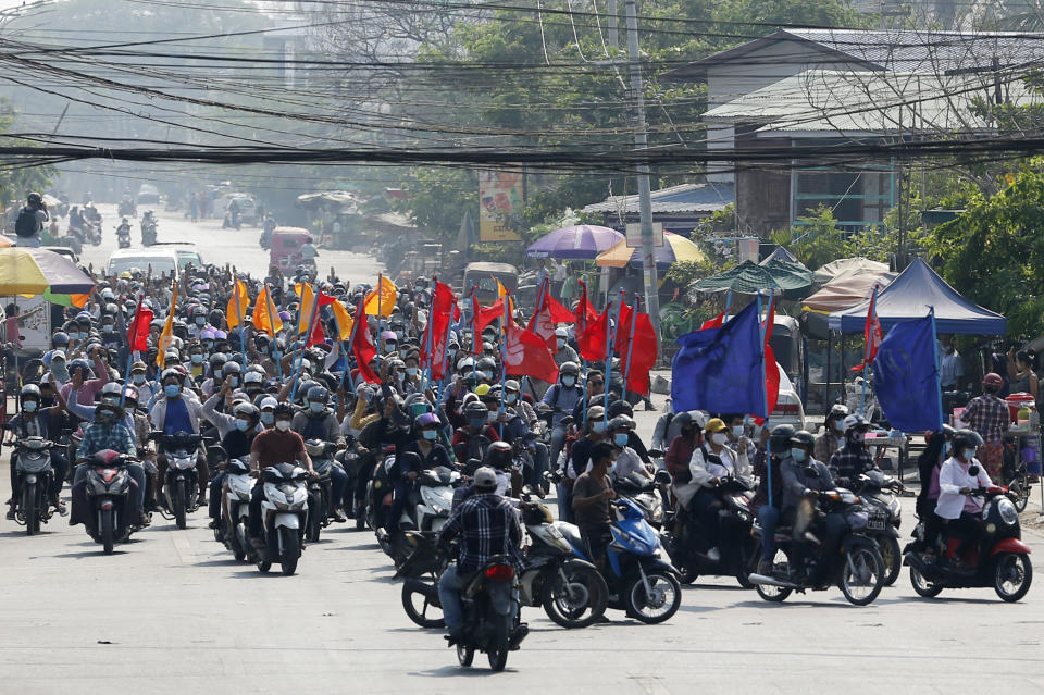 Protesters carry flags as they drive their motorcycles during an anti-coup protest in Mandalay, Myanmar on Thursday March 25, 2021. Protesters against last month's military takeover in Myanmar returned to the streets in large numbers Thursday, a day after staging a "silence strike" in which people were urged to stay home and businesses to close for the day. (AP Photo)