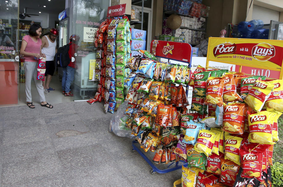 People shop at a well-stocked convenient in Hanoi, Vietnam, Thursday, Feb. 21, 2019. Vietnam, the location of President Donald Trump's next meeting with North Korean leader Kim Jong Un, has come along way since the Us abandoned its war against communist North Vietnam in the 1970s. (AP Photo/Minh Hoang)