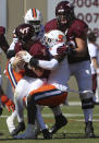 Virginia Tech quarterback Braxton Burmeister (3) is sacked by Syracuse's Marlowe Wax (2) during the first half of of an NCAA college football game in Blacksburg Va., Saturday, Oct. 23 2021. (Matt Gentry/The Roanoke Times via AP)