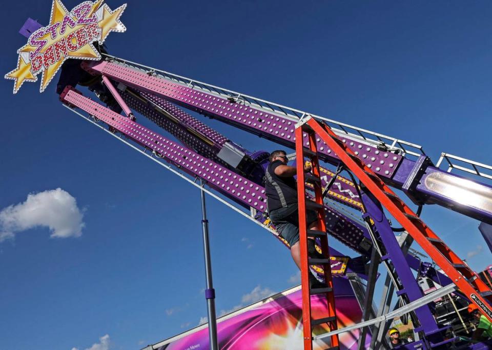 The Youth Fair attractions are disassembled by workers on what was to have been opening day after it was postponed under an emergency directive from Miami-Dade County Mayor Carlos Gimenez on Thursday, March 12, 2020. The Youth Fair organization is currently working on a policy for ticket holders and will announce it once it is finalized, according to The Youth Fair’s main office.