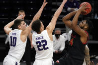 Maryland forward Donta Scott, right, shoots against Northwestern forward Miller Kopp, left, and forward Pete Nance during the first half of an NCAA college basketball game in Evanston, Ill., Wednesday, March 3, 2021. (AP Photo/Nam Y. Huh)