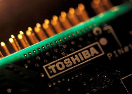 A logo of Toshiba Corp is seen on a printed circuit board in this photo illustration taken in Tokyo July 31, 2012. REUTERS/Yuriko Nakao/Files