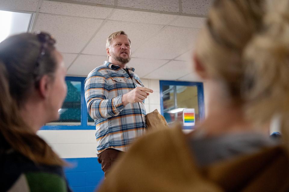 Brooke Heaton stands on a table to address the crowd at at an informational event on the Malvern Hills Pool, February 21, 2024.