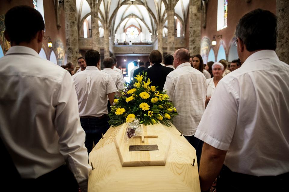 One of the two coffins is seen being carried during Saturday's funeral service.&nbsp; (Photo: OLIVIER MAIRE via Getty Images)