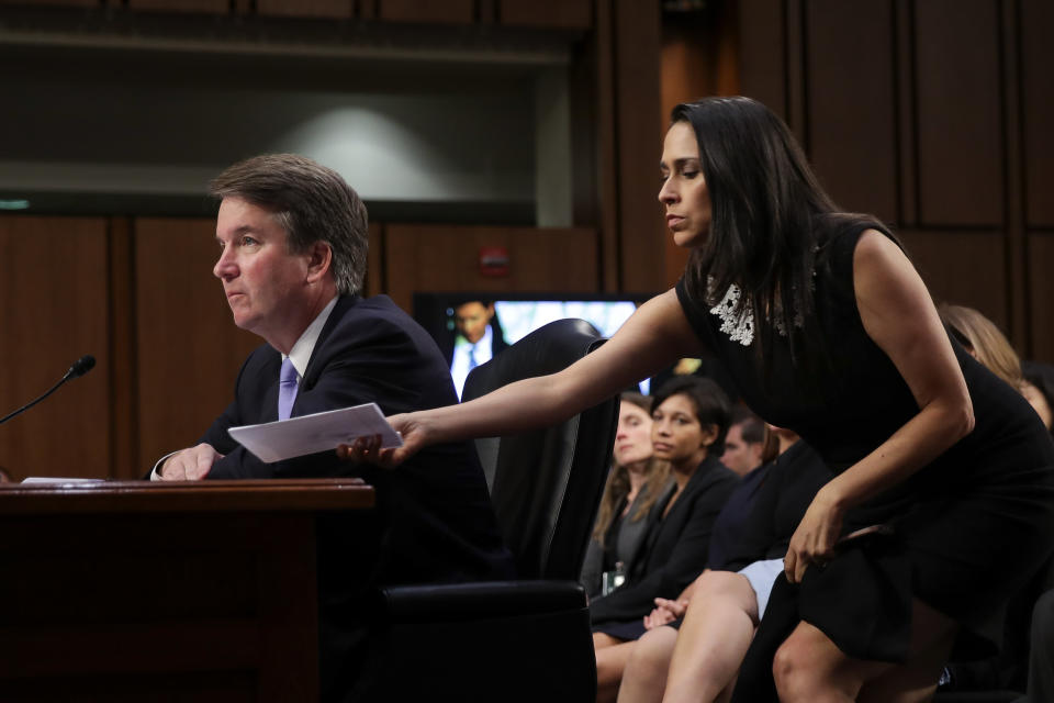 Supreme Court nominee Brett Kavanaugh testifies before the Senate Judiciary Committee earlier this month as former clerk Zina Bash hands him a note. (Photo: Drew Angerer via Getty Images)
